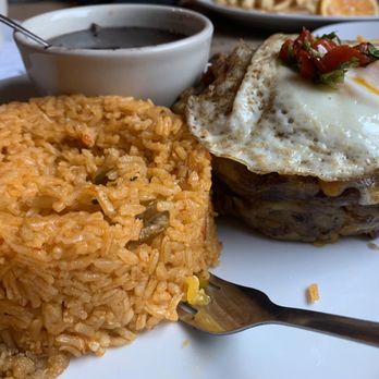 Rice and Beans - Pionono Mashed sweet plantain filled with savory beef picadillo, melted cheese & fried egg side [yellow] rice and my choice of black beans - Puerto Rican Near Me - Wesley Chapel, Florida