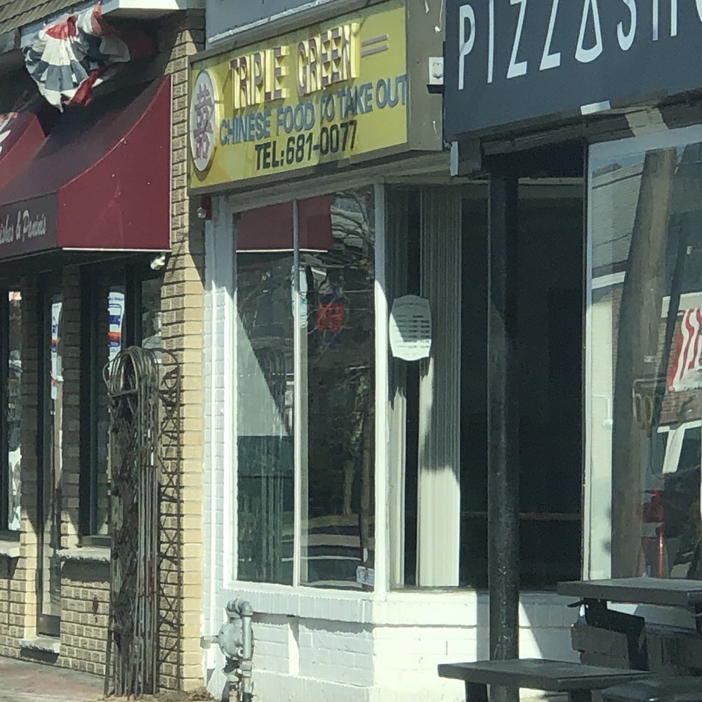 a pizza shop on a city street a pizza shop on a city street