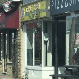 a pizza shop on a city street a pizza shop on a city street