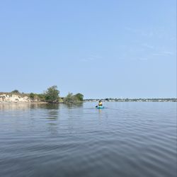 Pogies Fishing Center - This is a kayak on the water floating.