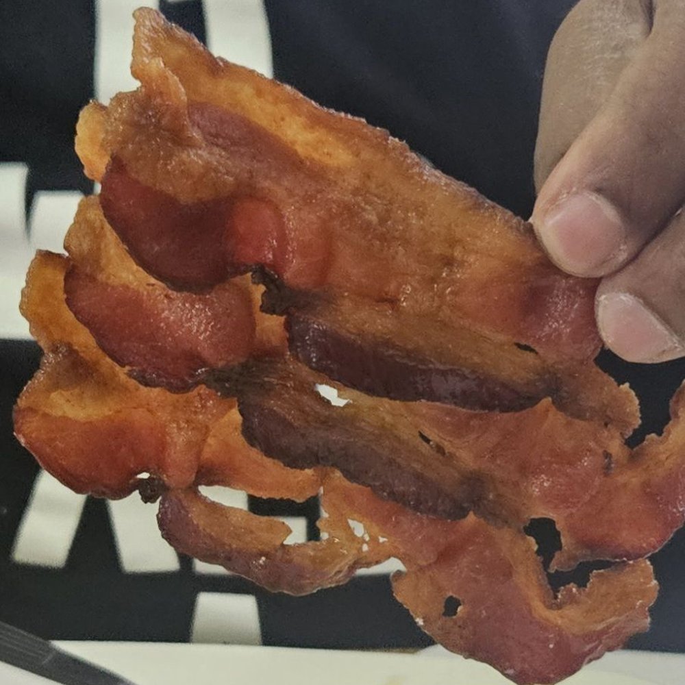 Bacon slices were cooked in one piece. Bacon slices were cooked in one piece.