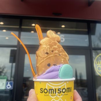 Somisomi - Close up of Ube Swirl topped with Upside down Taiyaki with custard filling, coconut flakes and macaron - Ice Cream & Frozen Yogurt Near Me - Pleasanton, California