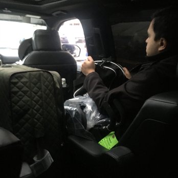 Ride in Bliss - Sitting with a duffel bag and stroller the driver placed on him - Limos Near Me - Chicago, Illinois