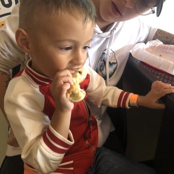 Jakes Coney Island - a young boy eating a donut - Hot Dogs Near Me - Edmond, Oklahoma