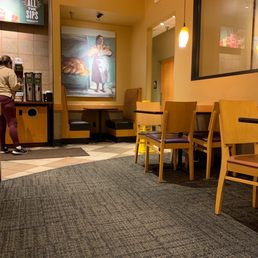 a woman standing in a restaurant a woman standing in a restaurant
