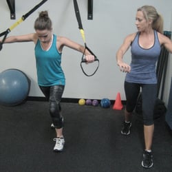 Tri Valley Trainer - Melissa takes Katie through the TRX chest press.