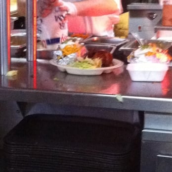Beef and Bun Barbecue - Cook pouring the sour cream and half chicken, salad, and potatoe - Barbeque Near Me - Houston, Texas Beef and Bun Barbecue - Cook pouring the sour cream and half chicken, salad, and potatoe - Barbeque Near Me - Houston, Texas