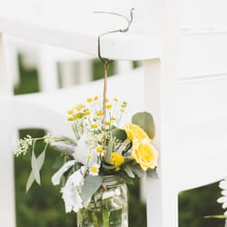 Flowers hanging on the chairs along the aisle for my ceremony