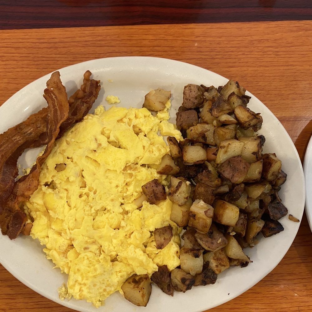 Sunnyside Cafe - Two eggs with home fries and bacon. Yes two eggs. Huge portion. - Cafes Near Me - Melbourne Beach, Florida Sunnyside Cafe - Two eggs with home fries and bacon. Yes two eggs. Huge portion. - Cafes Near Me - Melbourne Beach, Florida