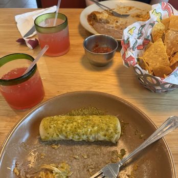 Little Mexico - A mostly eaten plate of chicken enchiladas with rice and beans and a strawberry margarita to drink. - Mexican Near Me - Richmond, Virginia
