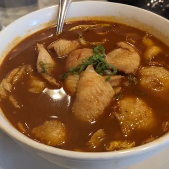 Sei Bar - 水煮魚 - A bowl of water boiled fish featuring fish fillets in a spicy broth, garnished with chopped green onions. - Chinese Near Me - Wakefield, Massachusetts