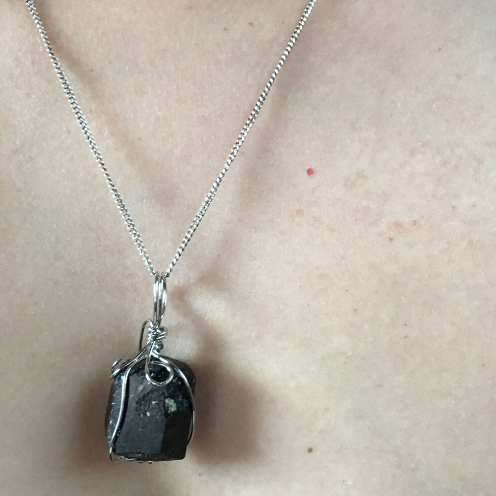Black tourmaline.  The lady behind the counter told me that I absorb other people's energy. The black tourmaline deflects it!