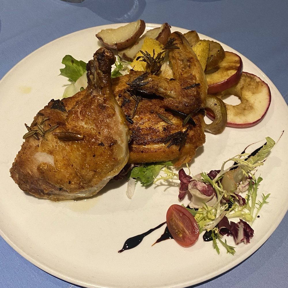 Parma - Pollo al Mattone alla Diavola Spicy pan-seared half chicken served with roasted potatoes and grilled fruit - Italian Near Me - Fresno, California Parma - Pollo al Mattone alla Diavola Spicy pan-seared half chicken served with roasted potatoes and grilled fruit - Italian Near Me - Fresno, California