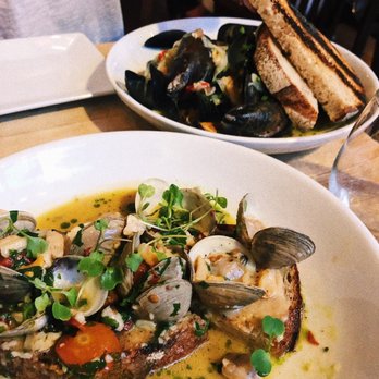 Mercato - Clam toast at the forefront, mussels toward the back. Both divine - Italian Near Me - Philadelphia, Pennsylvania Mercato - Clam toast at the forefront, mussels toward the back. Both divine - Italian Near Me - Philadelphia, Pennsylvania
