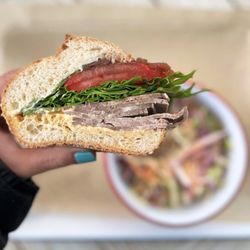 Iggy's Place - Cold Cut Beef Tongue Sandwich w/ balsamic reduced onion, arugula, tomatoes, garlic+sriarcha aioli, rize up seeded hoagie | $18 + $6 slaw