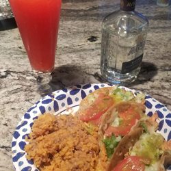 3 chicken tacos with beans an rice