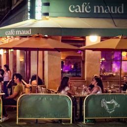 Exterior outside entrance of Café Maud - Sidewalk seating in the evening - New York, New York Exterior outside entrance of Café Maud - Sidewalk seating in the evening - New York, New York