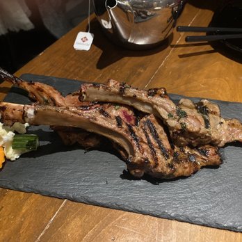 Les Street Monkeys - grilled lamb chops on a slate platter - Cambodian Near Me - Montreal, Quebec Les Street Monkeys - grilled lamb chops on a slate platter - Cambodian Near Me - Montreal, Quebec