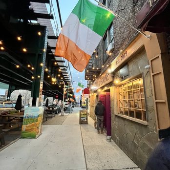 The Wild Goose - a man holding a irish flag - Sports Bars Near Me - Woodside, New York The Wild Goose - a man holding a irish flag - Sports Bars Near Me - Woodside, New York