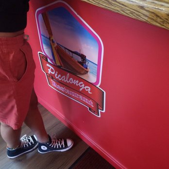 Picalonga Restaurant - a child standing at the counter - Dominican Near Me - Boston, Massachusetts