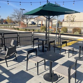 Starbucks - a patio with tables and chairs and an umbrella - Coffee & Tea Near Me - Joliet, Illinois Starbucks - a patio with tables and chairs and an umbrella - Coffee & Tea Near Me - Joliet, Illinois