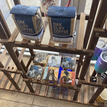 Gahwena Coffee Station - Travel mug, Oak Cliff coffee, local art for sale on wooden shelves. - Coffee & Tea Near Me - Duncanville, Texas