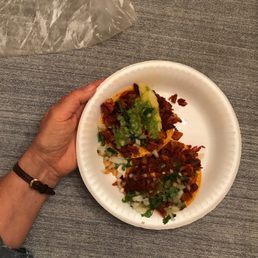 a person holding a plate of food a person holding a plate of food