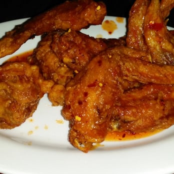 Simply Khmer - Fried spicy wings, minus 1 in my hand  (sorry) - Cambodian Near Me - Lowell, Massachusetts