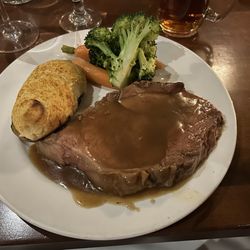 The CattleBaron Steakhouse & Bar - Baron cut Prime Rib with twice baked potato (toppings come around later) seasonal veggies
