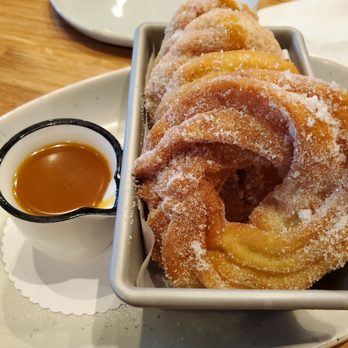 Mahi’ai Table - Malasada cruellers with Lilikoi caramel sauce. - Cocktail Bars Near Me - Kapolei, Hawaii