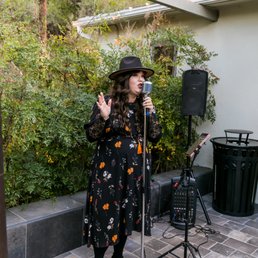 a woman singing into a microphone a woman singing into a microphone