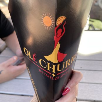 Ole Churros - a woman holding a bottle of ole chucho - Spanish Near Me - Paradise, Nevada Ole Churros - a woman holding a bottle of ole chucho - Spanish Near Me - Paradise, Nevada