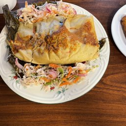 Guatemalan pork tamale in a banana leaf with traditional cabbage Curtido on the side - delicious!