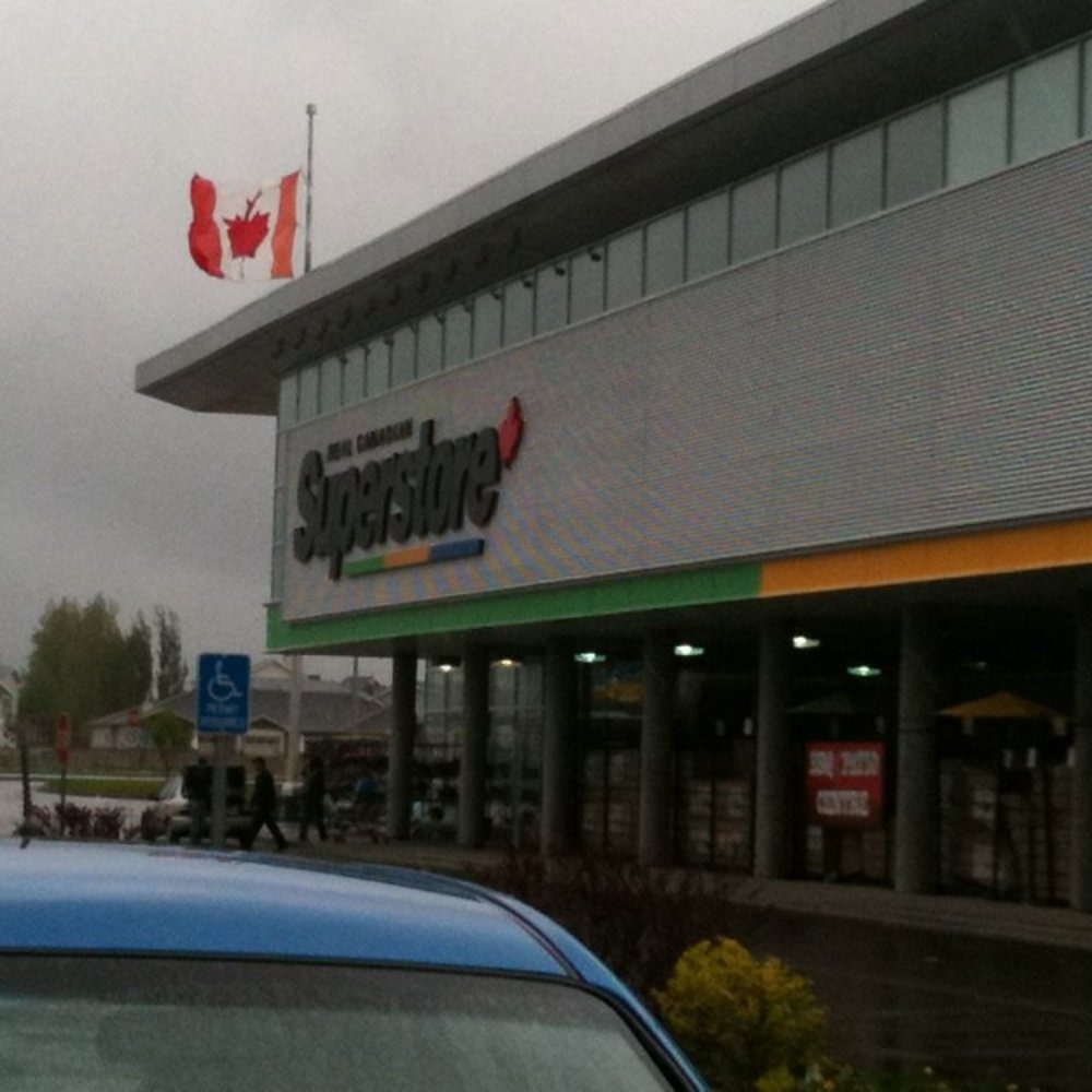 Real Canadian Superstore Eyewear - The front of the store on a rainy day. - Lethbridge, Alberta Real Canadian Superstore Eyewear - The front of the store on a rainy day. - Lethbridge, Alberta