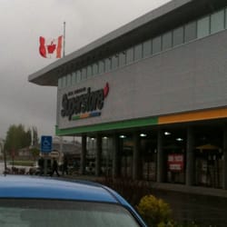 Real Canadian Superstore Eyewear - The front of the store on a rainy day.