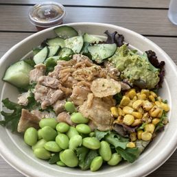 Marinated chicken, cucumber, guacamole, mixed greens, corn, edamame, rice, fried onions  Simple and tasty :)