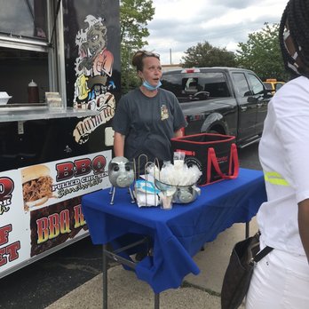 Hogz Backyard BBQ - a man and a woman standing in front of a food truck - Food Trucks Near Me Hogz Backyard BBQ - a man and a woman standing in front of a food truck - Food Trucks Near Me