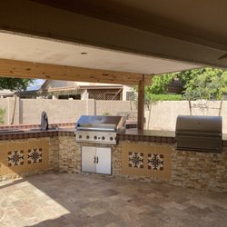 Tranquil Oasis Landscapes - outdoor kitchen with travertine pavers