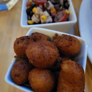 Reel Seafood Grill - Hush puppies and corn & black bean salad - Seafood Near Me - Greensboro, North Carolina Reel Seafood Grill - Hush puppies and corn & black bean salad - Seafood Near Me - Greensboro, North Carolina