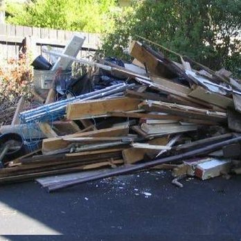 Clay's Clean Up - a pile of wood - Landscaping Near Me