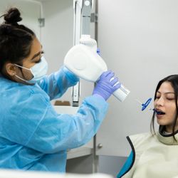UEI College - Huntington Park - Dental Assistant students performing tasks on each other.