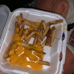 cheese fries in a styrofoam container