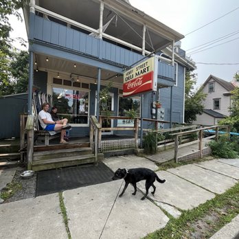 Henry Street Deli - Liberty outside the exterior of Henry St Deli while two beautiful people admire her splendor. - Delis Near Me - Burlington, Vermont