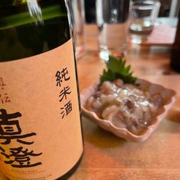 a bottle of sake sitting on a table a bottle of sake sitting on a table