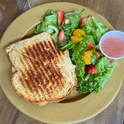 The Farmhouse Eatery & Gifts - Chicken salad panini and fresh greens with mandarin oranges and strawberries served with the Farmhouse salad dressing.