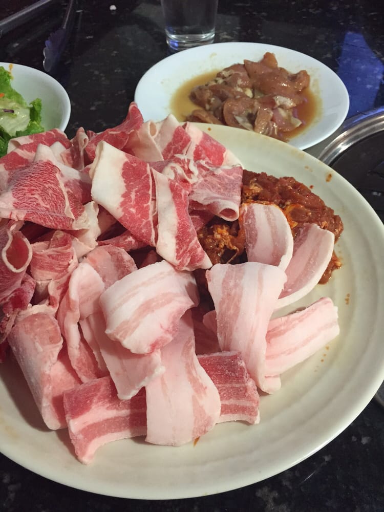Chicken (on small plate), brisket, pork belly and spicy pork Yelp