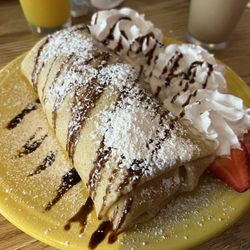 Puffy cream cheese crepe with fresh banana and strawberries.