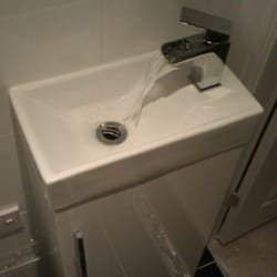 joseph barker plumbing & heating - wash hand basin and waterfall toilet inset in unit