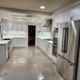 Gallery style kitchen with white shaker, quartz countertop, and glass mosaic pebble backsplash. Gallery style kitchen with white shaker, quartz countertop, and glass mosaic pebble backsplash.