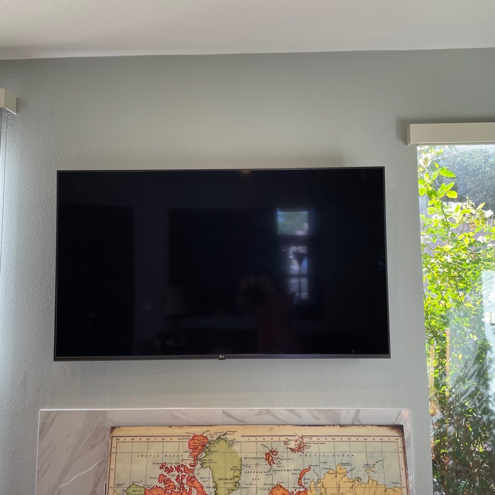 Tixan Construction - Tv mounted perfectly with the middle seam of the fireplace - General Contractors Near Me